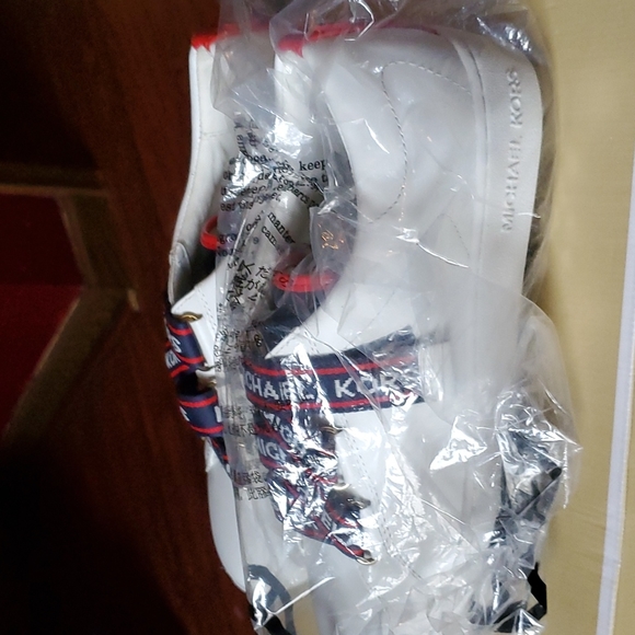 mk sneakers. color  white with logo across  in red n blue. - Picture 2 of 4